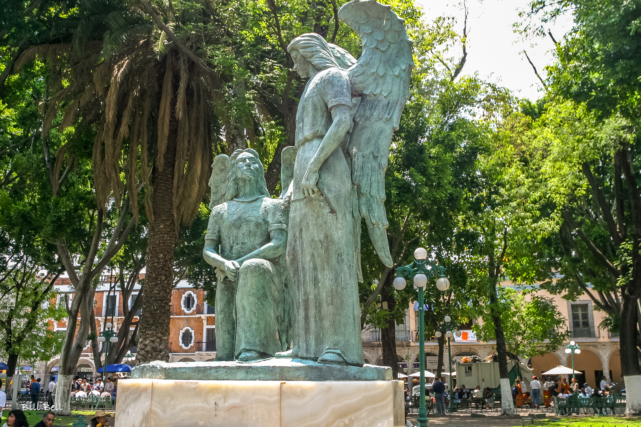 A serene statue of an angel watching over a tranquil park in Puebla, capturing the city's blend of spiritual and artistic beauty.