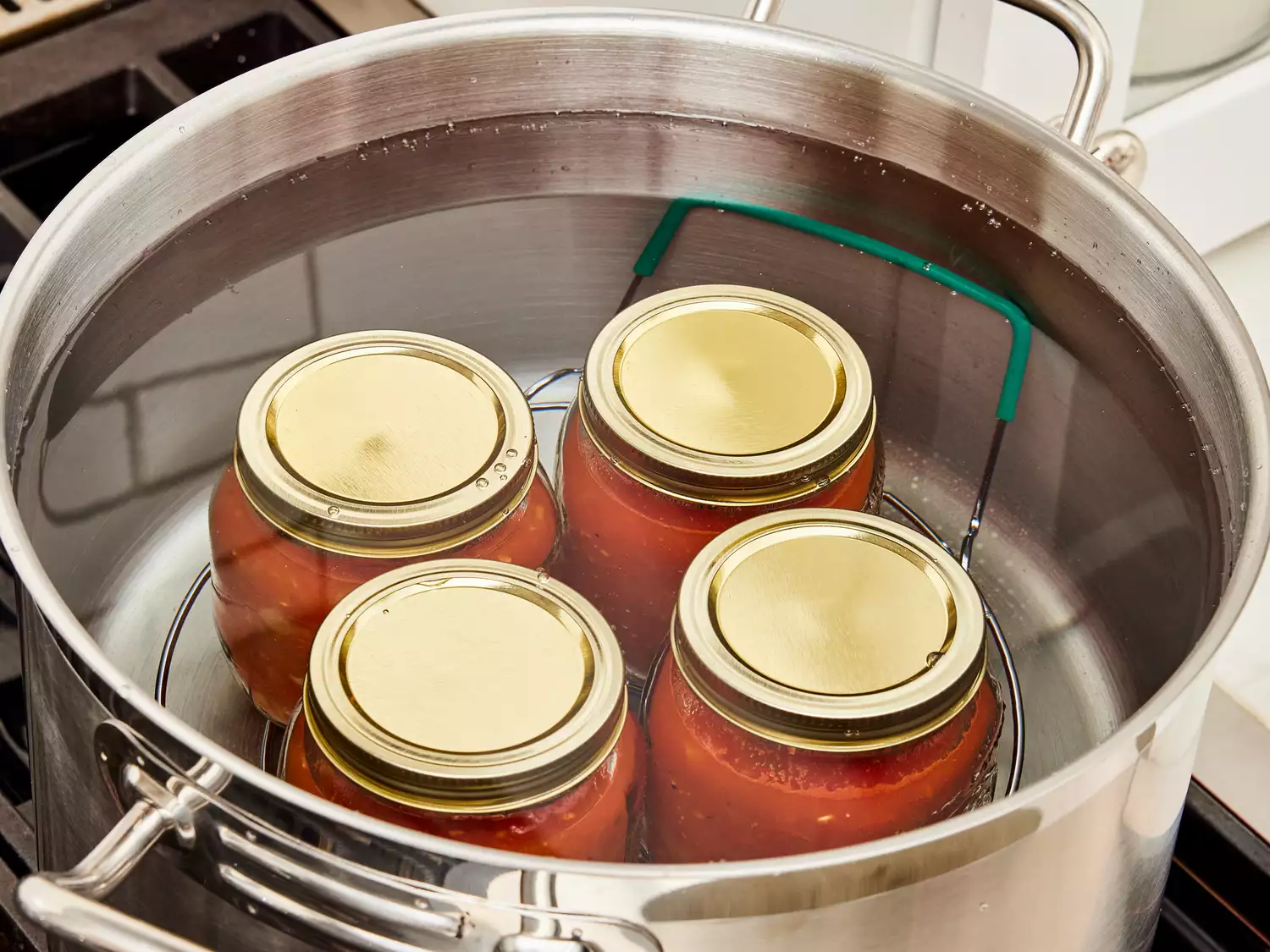 Jars placed in water, coming to a boil.