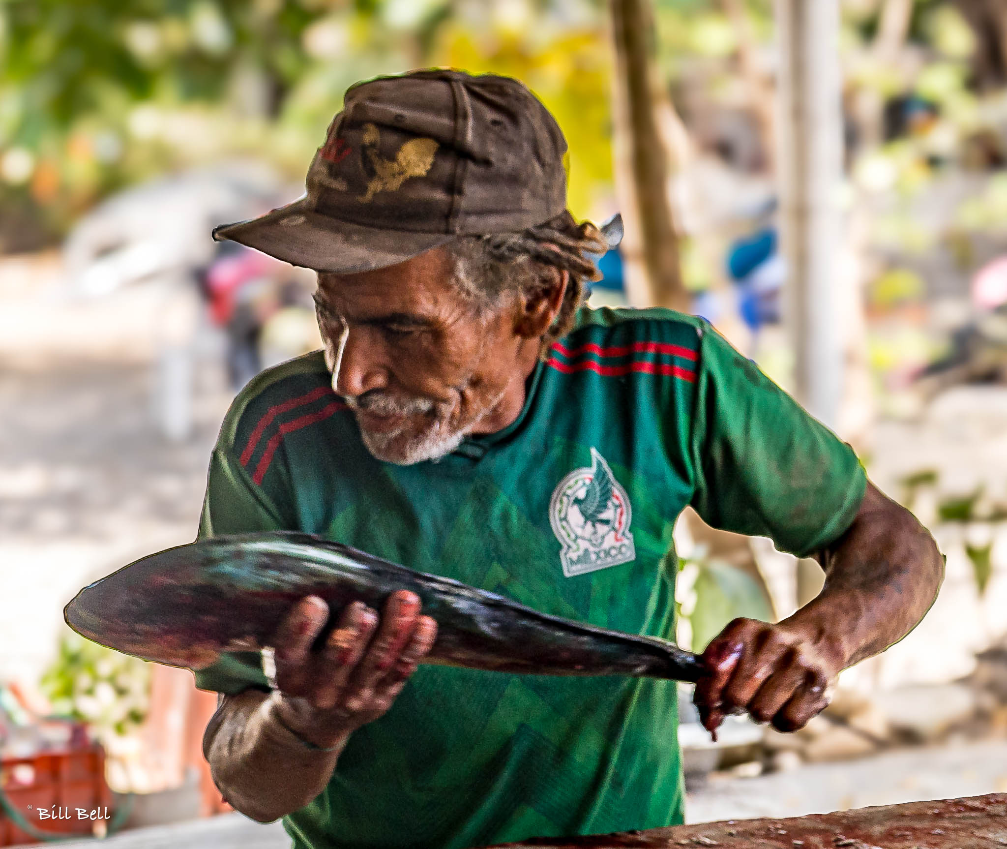 A fisherman holding his catch in La Peñita
