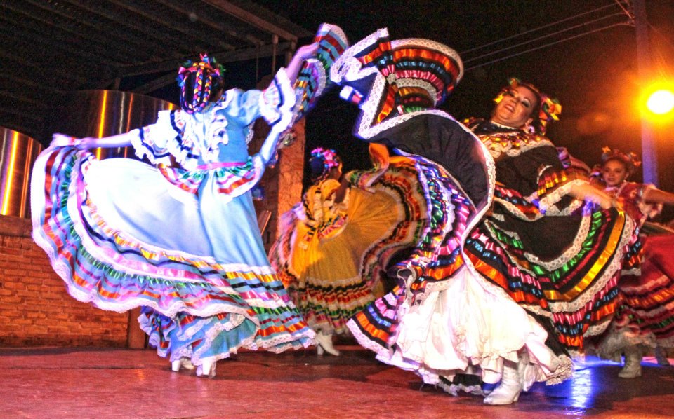 Folklórico dancers sweeping colourful skirts through the air